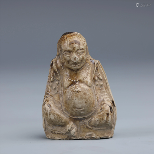 A CHINESE CELADON GLAZED PORCELAIN FIGURINE OF BUDDHA