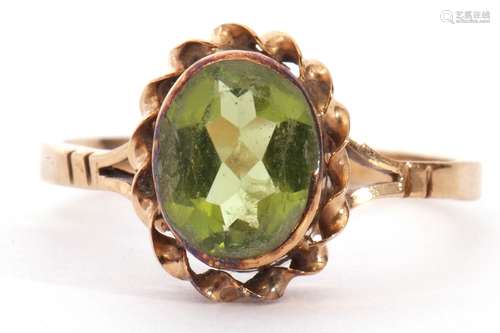 9ct gold peridot single stone ring, the oval faceted peridot...