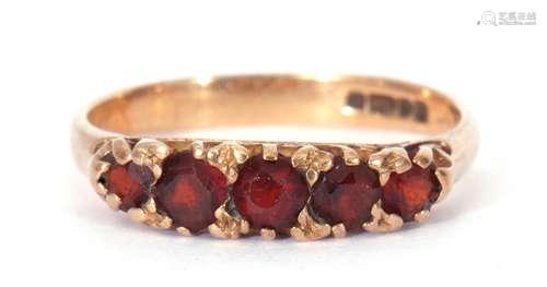 9ct gold and garnet ring, line set with five graduated round...