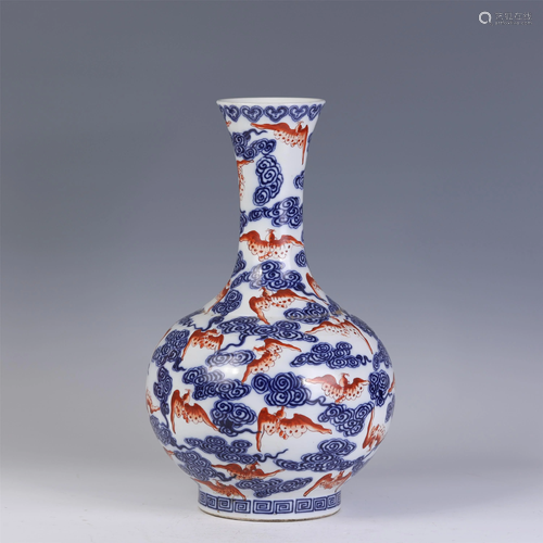 A CHINESE BLUE AND WHITE IRON-RED CLOUDS AND BATS VASE