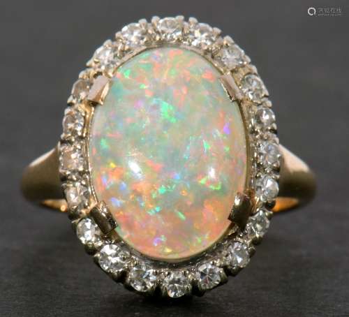Opal and diamond cluster ring, the oval shaped cabochon opal...