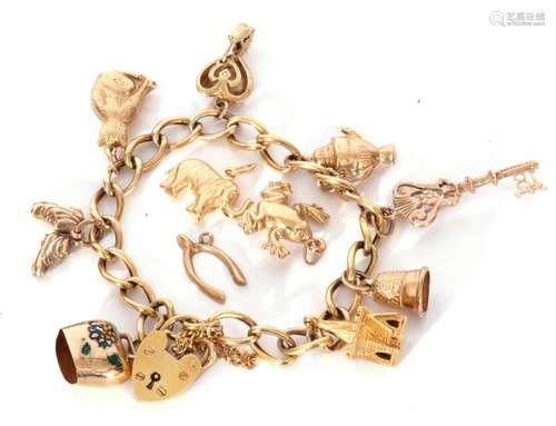 9ct gold curb link bracelet suspending various charms to inc...