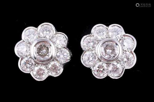 A pair of diamond flower head cluster earrings