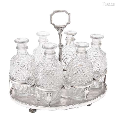 Y A cased George III silver mounted oval six bottle decanter...