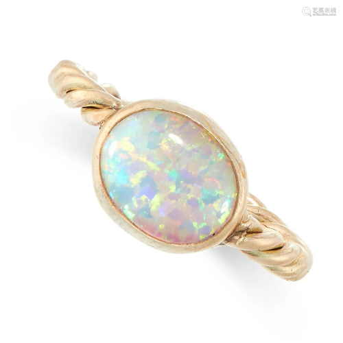 A SYNTHETIC OPAL RING in yellow gold, set with an oval
