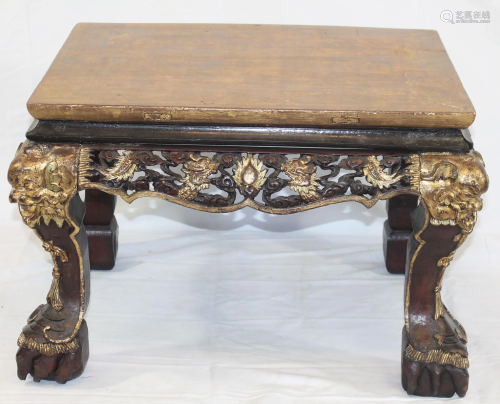 Chinese heavily carved table w large paw feet & gold