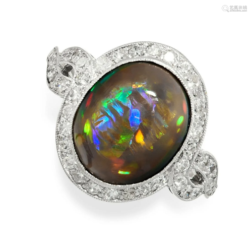 A FINE BLACK OPAL AND DIAMOND RING set with an oval