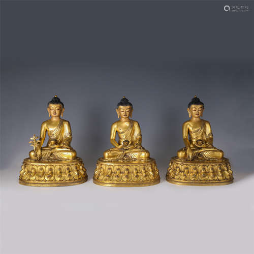 A SET OF THREE CHINESE GILT BRONZE FIGURE OF BUDDHA SEATED S...