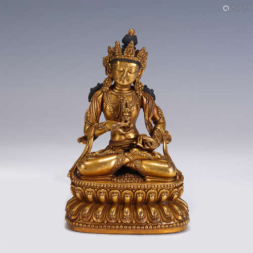 A CHINESE MING STYLE GILT BRONZE FIGURE OF BUDDHA SEATED STA...