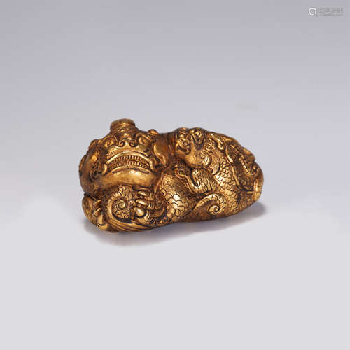 A CHINESE QING STYLE GILT BRONZE AUSPICIOUS BEAST PAPER WEIG...