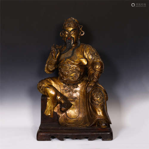 A CHINESE GILT BRONZE GUANGONG SEATED STATUE