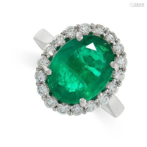AN EMERALD AND DIAMOND RING in platinum, designed as a