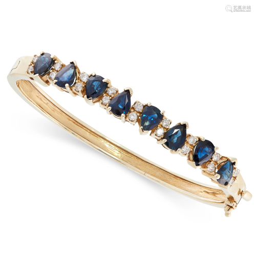 A SAPPHIRE AND DIAMOND BANGLE in 14ct yellow gold,