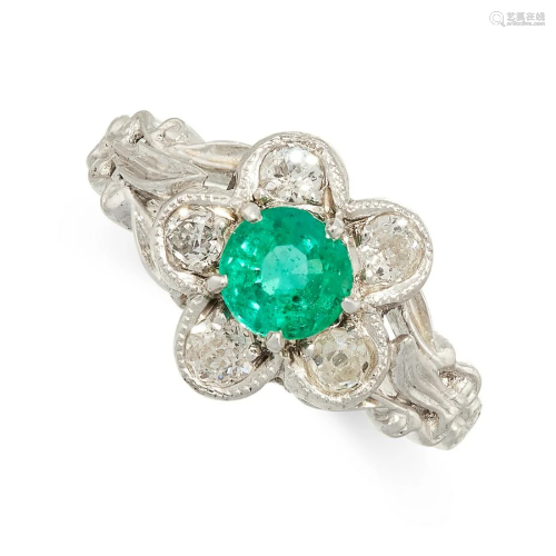 AN EMERALD AND DIAMOND RING set with a round cut