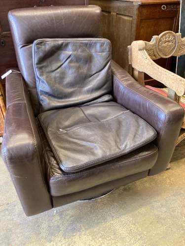 An Italian brown leather swivel armchair and two cushions, w...