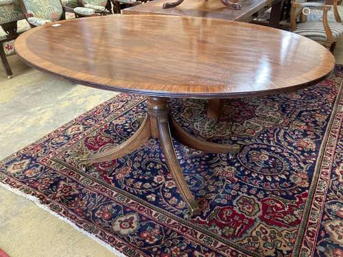 A Regency style oval banded mahogany dining table, length 15...