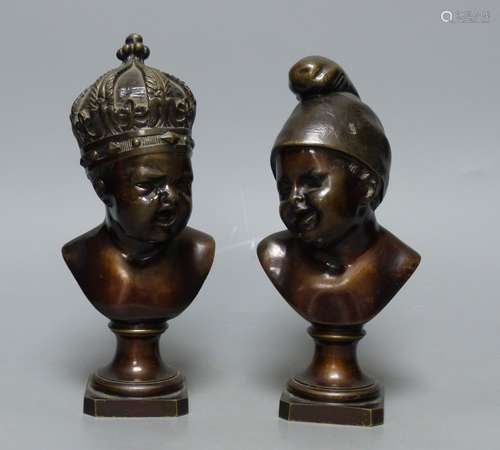 A small bronze bust of a child wearing a crown and another s...