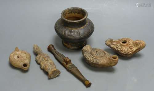 A group of antiquities, three oil lamps, a vase and a figure...