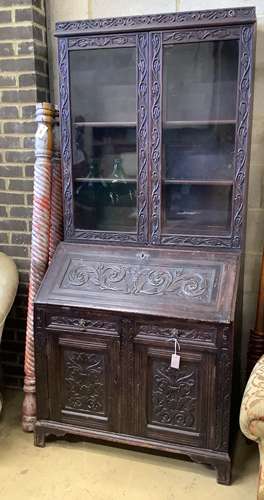 A Victorian carved oak bureau bookcase, width 94cm, depth 54...