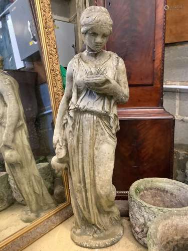 A reconstituted stone garden ornament of a lady with ewer, h...