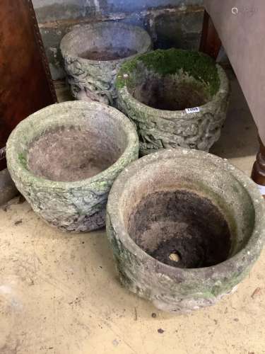 A set of four circular reconstituted stone garden planters, ...