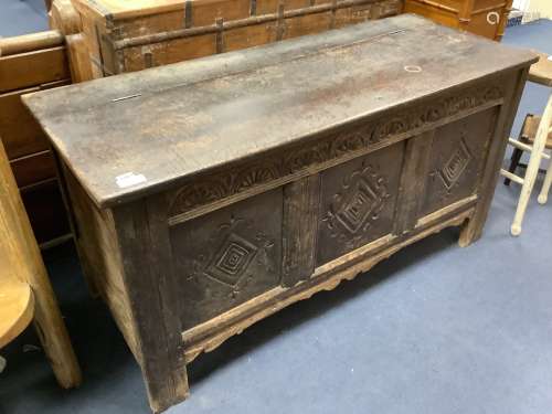 An early 18th century carved panelled oak coffer, length 143...