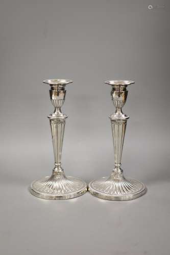 A pair of late Victorian silver oval candlesticks, with engr...