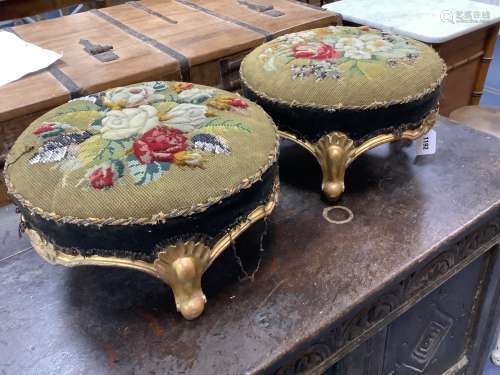 A pair of Victorian floral tapestry circular carved giltwood...