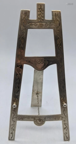 An early 20th century silver folding easel, etched