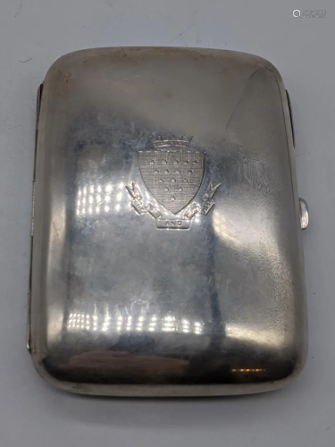 A silver cigar case, crest to the front One And All,