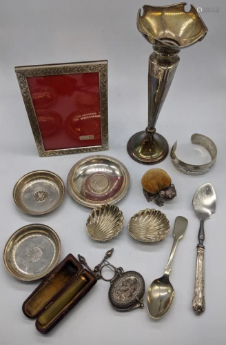 A collection of items, mostly silver