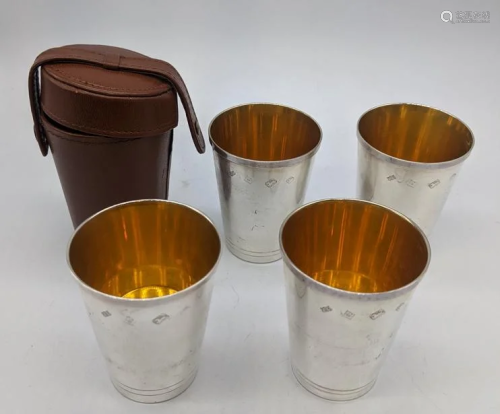 A set of four contemporary silver travel beaker with