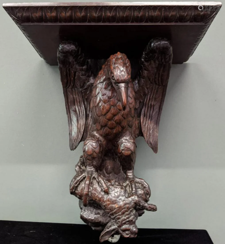 A 19th century oak carved wall sconce in the form of an