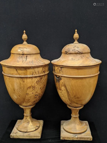 A pair of Regency olive wood urns, acorn finials,