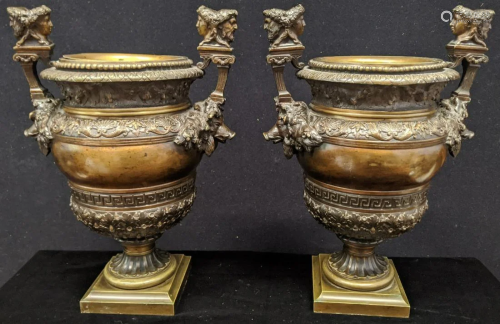 A pair of 19th century bronze urns, flanked by boar
