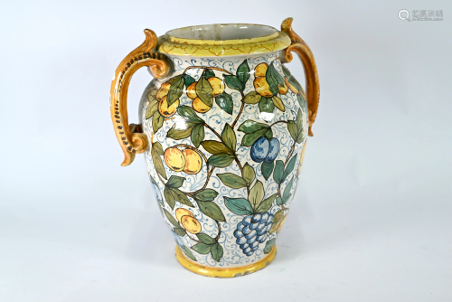 A large majolica decorative vase with twin scroll