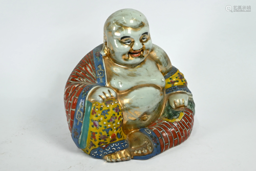 A Chinese polychrome and gilt decorated figure of