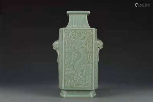 A QING DYNASTY QIANLONG PEA GREEN GLAZE RELIEF CLOUD AND DRA...