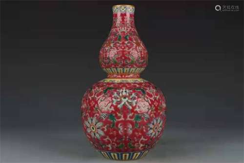 A QING DYNASTY QIANLONG CARMINE RED GROUND GOURD BOTTLE