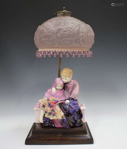 A Royal Doulton figure group lampbase, The Flower Seller's C...