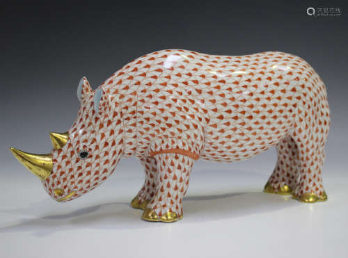 A large Herend porcelain rhinoceros with iron red scale deco...