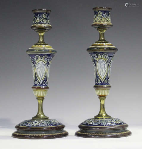 A pair of brass mounted Doulton Lambeth candlesticks, late 1...