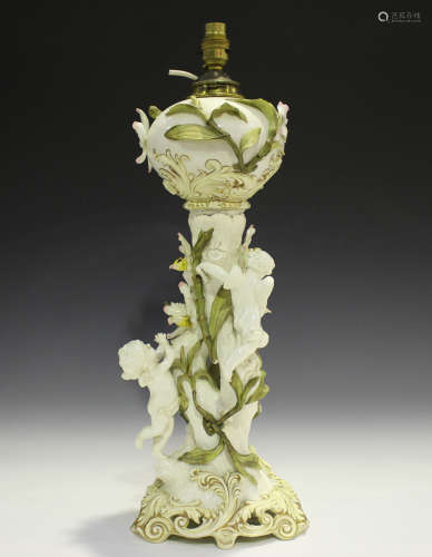 A Moore Brothers oil lamp, late 19th century, the trunk stem...
