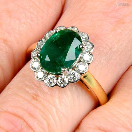 An emerald and diamond cluster ring.