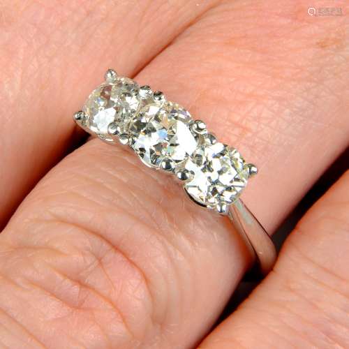 A platinum old-cut diamond three-stone ring.Estimated total ...
