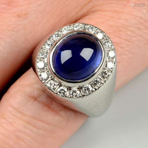 A sapphire cabochon and brilliant-cut diamond cluster ring.S...