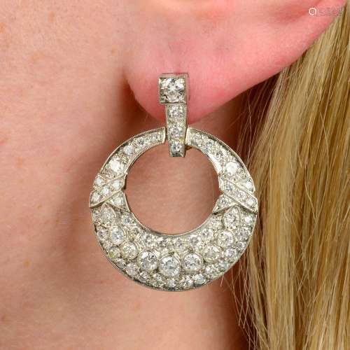 A pair of pavé-set diamond stylised garland motif earrings.E...