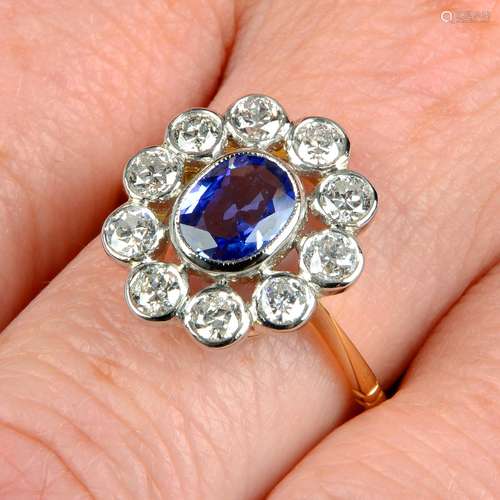 A sapphire and circular-cut diamond collet cluster ring.Sapp...