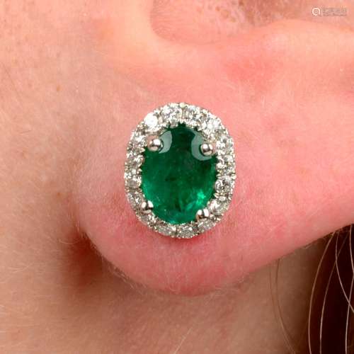 A pair of emerald and diamond cluster earrings.Total emerald...
