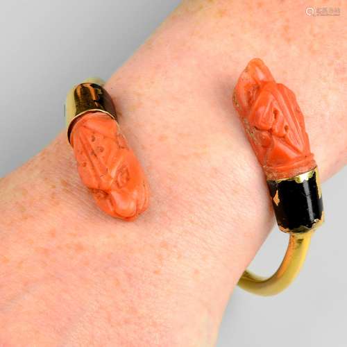 A cuff bangle, with carved coral animal and black enamel asy...